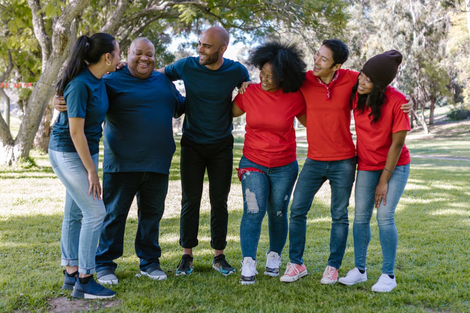 A diverse group of community members together outdoors