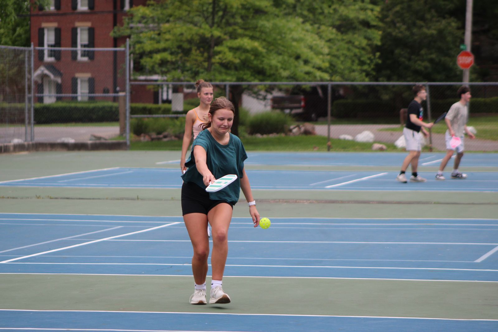 People enjoying a game of pickleball on an outdoor court